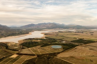 Fields, irrigation basin, river, clouds, sky, dirt road, meadows, bushes, mountains,