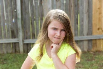 Kid girl with disappoint expression finger thinking expression outdoor