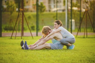 Young in love heterosexual Caucasian couple, man with beard woman with big breasts doing exercise