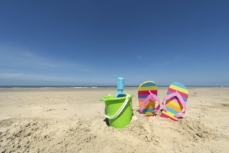 Summer beach with toys and flip flops