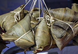 Steamed Chinese sticky rice dumplings wrapped in bamboo leaves