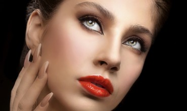 Beautiful facial shot of a female model with expressive eyes and red lips