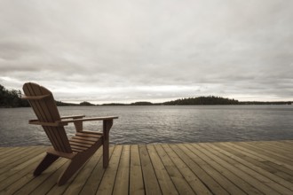 Known as Muskoka or Adirondack chairs sit on a dock at a resort in Muskoka, Ontario, Canada, North