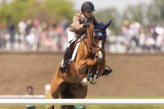 Elena A. Haas, from the United States and riding Claude, compete in the 1.60m Grand Prix during The