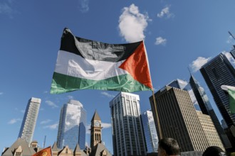 Toronto, Canada - 28 October 2023: Palestinian flag flies high amidst the city skyline, with