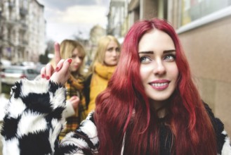 Self-confident teenage girl ignores jealous people who spread gossip behind her back. stop bullying
