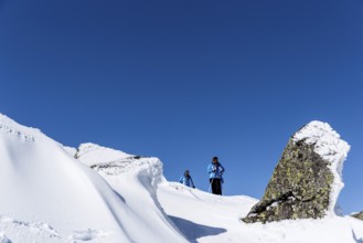 Sofia, Bulgaria - March 12, 2016: Two free riders are prepairing for skiing down a snowy rocky