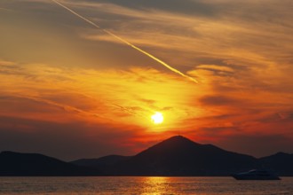 Sunset in Montenegro over the mountains and the sea. Orange sunsets