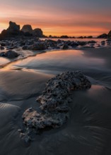 This is a color landscape photo of a vivid sunset over the Pacific Ocean