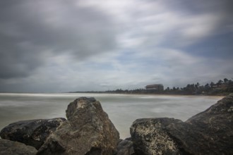 Beach, with lava rocks and vegetation, view of the sea in the evening at sunset. Landscape with