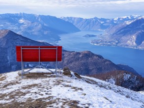 Big red bench on the landscape of Lake Como