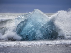Diamond Beach, iceberg in the surf, near Jökulsarlon glacier lagoon, Vatnajökull National Park,