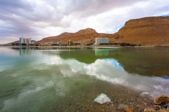 Quiet windless winter day. The smooth surface of the very salty sea water reflects the sky and