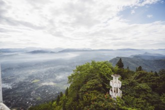 Panoramic view of a hilly, wooded landscape with a tower in the foreground, Anamanawa Tower, Sri