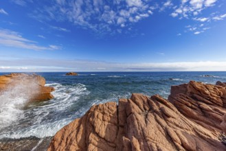Coastal landscape with red rocks and surf in blue sky and sunshine, Spiaggia di Cala E'Luas,