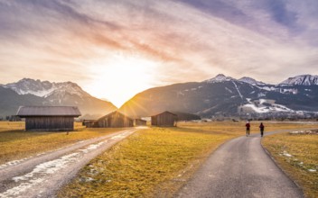 Winter landscape with mountain village in the Austrian Alps, wooden barns and country roads, at