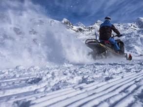 Snowmobile on a trail in the Italian alps