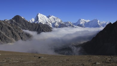 Sea of fog in the Gokyo Valley and snow capped high mountains of the Himalayas, Nepal, Asia