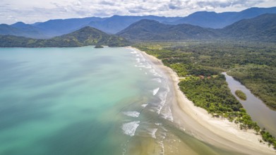Aerial view of Green Coast shoreline with turquoise water, beach, river and green mountains,