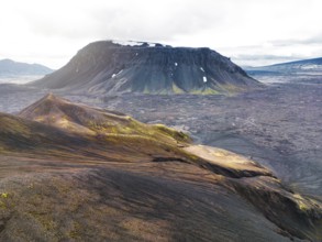 Remote volcanic lands somewhere in Iceland mainland, surrounded by vibrant green bushes and
