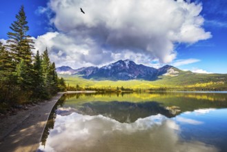 Frosty morning in the Rocky Mountains, Canada. Pyramid Mountain reflected in the smooth water of