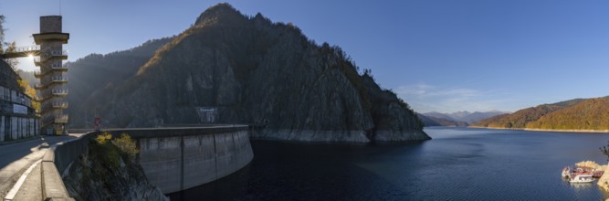 A panorama view of the Lake Vidraru reservoir and dam in the Fagaras mountains of central Romania