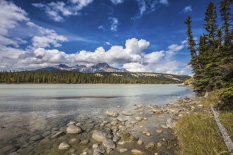 Evergreen forests and snow-capped Rocky Mountains of Canada. Beneaped Medicine Lake in the fall