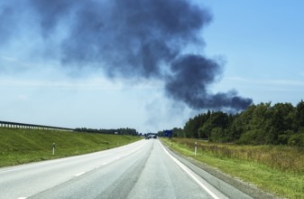 A big fire in the forest near the highway