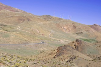 Tichka Pass, Col du Tichka, 2260m, Dry hilly landscape with a road and antenna structures under a