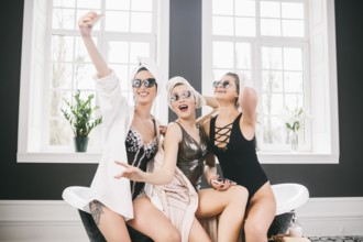 Picture showing group of happy friends in spa. girls with towels on heads having fun and taking