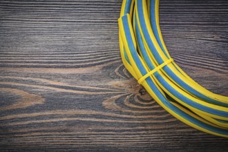 Coiled rubber hose on wooden board gardening concept
