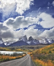 Picturesque clouds piled up in the blue sky. The gravel road goes to the famous cliffs of Los