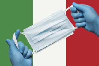 Medic holding respiratory face mask in hands in blue gloves on background flag of Italy or Italian