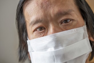 Corona pandemic: Asian male with mask