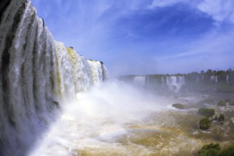 The most high-water waterfall in the world - Iguazu. White whipped foam of water and a thin mist