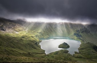 Sunrays through clouds over alpine lake, Schrecksee, Germany, Europe