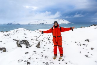 Man walks through ice and snow in Antarctica. Icebergs and everything frozen around you. Cold