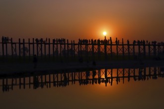 Famous U-Bein teak bridge at sunset on Taungthaman lake in Amarapura, Mandalay division, Myanmar,