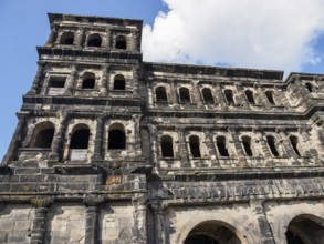 Historic stone architecture with many windows under a blue, cloudy sky, Trier, Germany, Europe