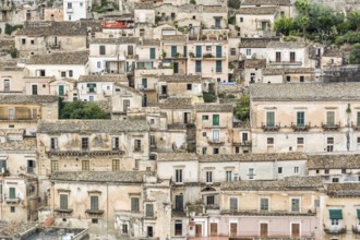 Typical ancient and picturesque town houses on a hill in Italy in the city of Modica on Sicily