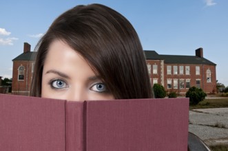 A beautiful young woman reading a book
