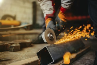 Close-up of a grinder cutting metal with sparks in a workshop setting