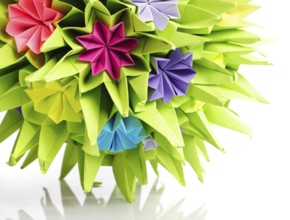 Colorfull origami kusudama from rainbow flowers isolated on white