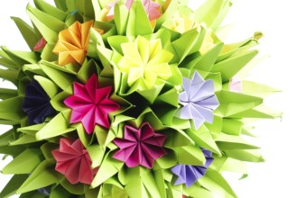 Colorfull origami kusudama from rainbow flowers isolated on white
