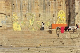 Varanasi, Uttar Pradesh, India, Asia, Wall paintings next to the steps of a Ganges Ghat with