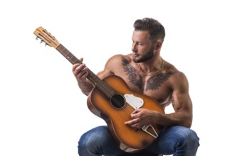 Portrait of muscular man with tattoo playing guitar. Isolated on white background. Full length shot