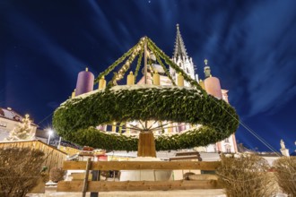 World's largest hanging Advent wreath, behind the basilica, main square of Mariazell, blue hour in