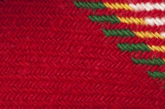 Handmade knit green and red background. Close up structure of the yarn. Christmas colors