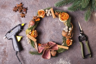 Christmas aromatic eco wreath with dry orange and anise stars, decorated tangerine peel roses,
