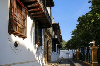 Side view to historic buildings in the Palace of Inquisition with artful woodwork and white